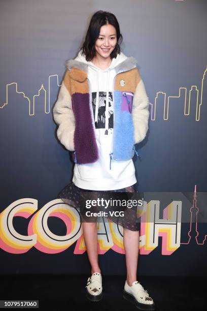 Model Liu Wen poses backstage during the Coach 2019 early autumn collection fashion show 'Coach Lights Up Shanghai' on December 8, 2018 in Shanghai,...