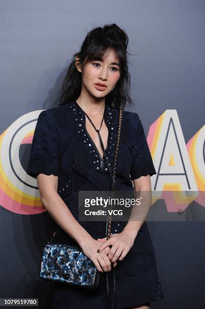 Actress/model Chen Ran poses backstage during the Coach 2019 early autumn collection fashion show 'Coach Lights Up Shanghai' on December 8, 2018 in...