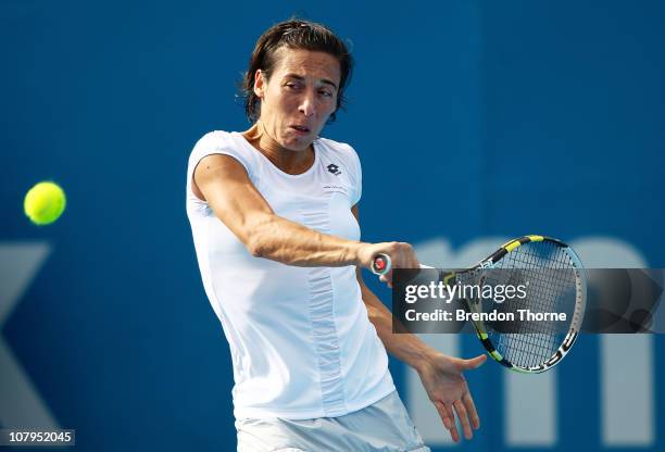 Francesca Schiavone of Italy plays a backhand in her match against Alisa Kleybanova of Russia during day two of the 2011 Medibank International at...