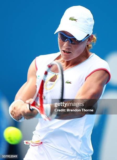 Samantha Stosur of Australia plays a backhand in her match against Yanina Wickmayer of Belgium during day two of the 2011 Medibank International at...
