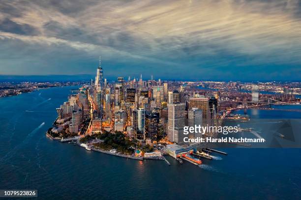 aerial view of manhattan island and harbor at dusk, new york city, new york state, united states - lower manhattan stock pictures, royalty-free photos & images
