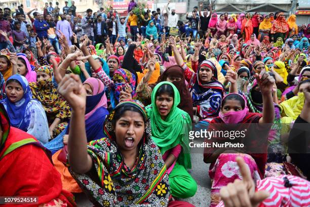 Bangladeshi garment workers shout slogans as they block a road during a demonstration to demand higher wages, in Dhaka, Bangladesh, on January 9,...