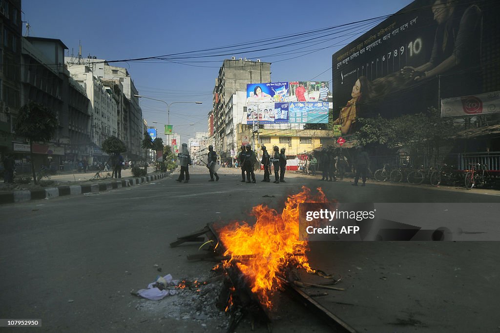 Bangladeshi police look on from behind b