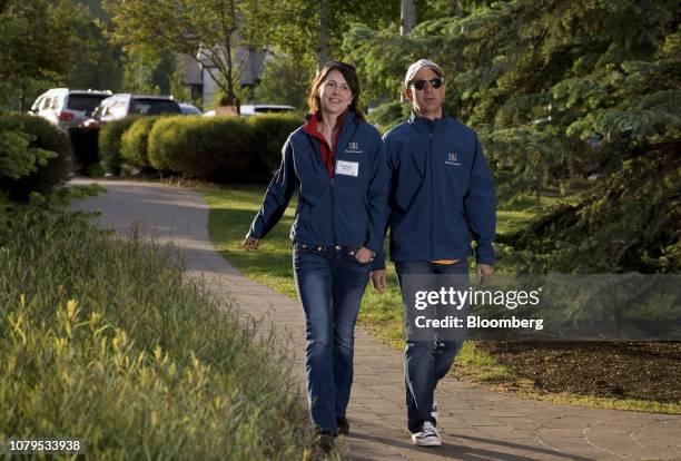 Jeff Bezos, founder and chief executive officer of Amazon.com Inc., and his wife MacKenzie Bezos, arrive for morning sessions at the 28th annual...