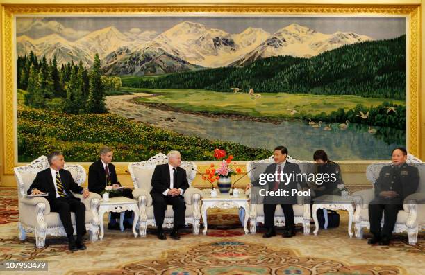 Secretary of Defense Robert Gates and China's Vice President Xi Jinping sit with members of their delegation during a meeting at the Great Hall of...