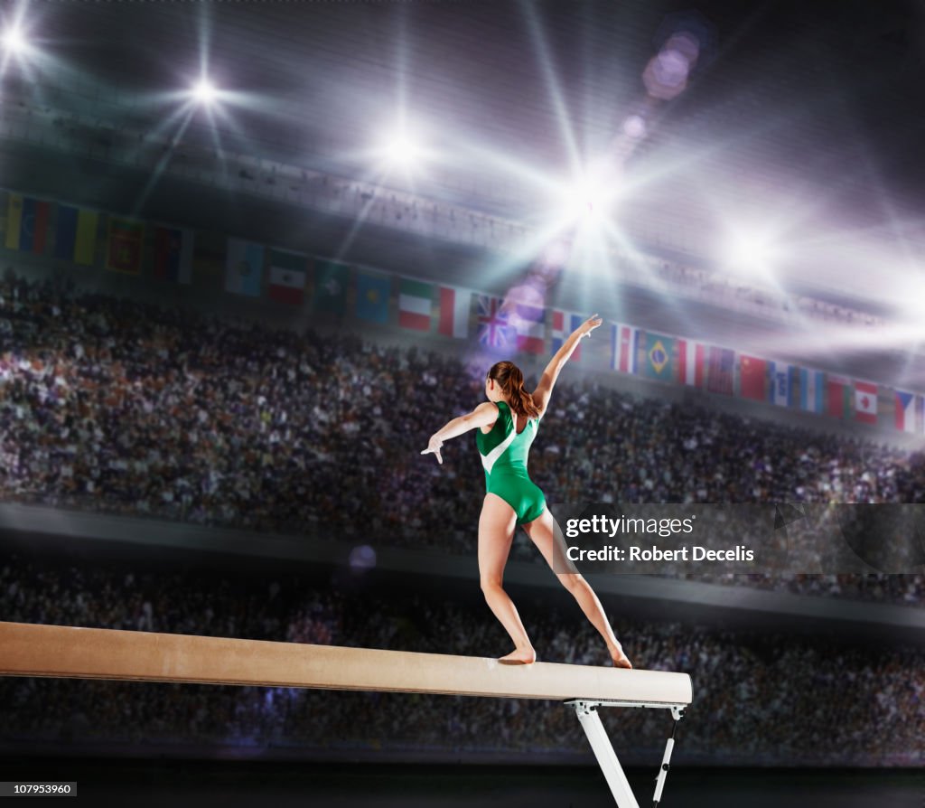 Female gymnast competing on balance beam