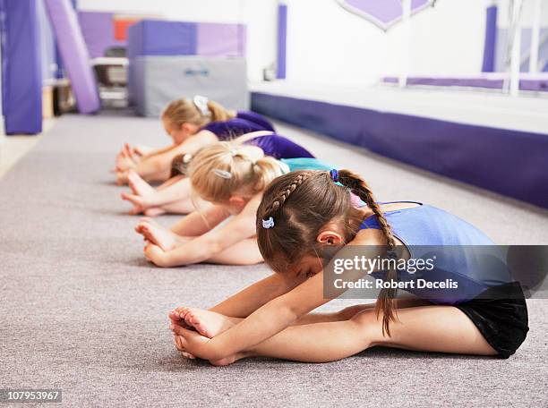 young gymnasts performing warming up routine - gymnastics imagens e fotografias de stock