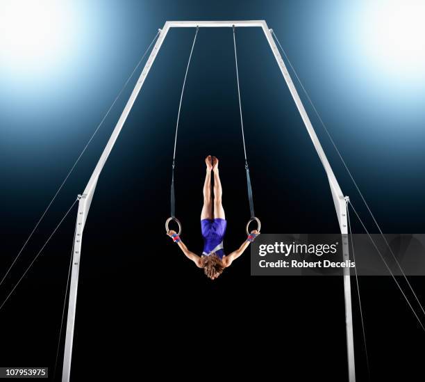 male gymnast upside down performing on rings - accuracy stock pictures, royalty-free photos & images