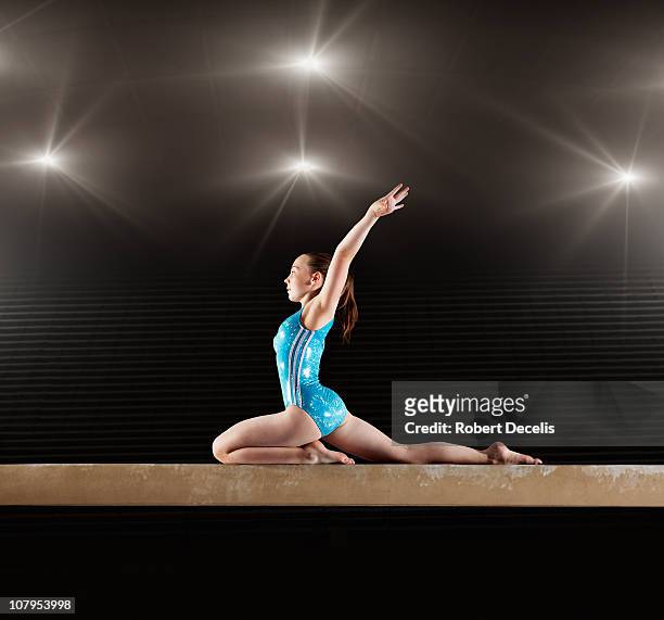 gymnast performing routine  on balance beam - bare feet kneeling girl stock pictures, royalty-free photos & images