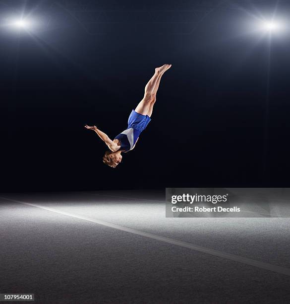 young male gymnast performing floor routine - backflipping stock pictures, royalty-free photos & images