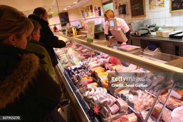 Shoppers buy organic sausage and other organic meat products at a branch of German organic grocery store chain Bio Company on January 10, 2011 in...