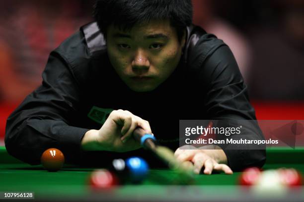 Ding Junhui of China plays a shot in his Round One match against Mark Williams of Wales during The Ladbrokesmobile Masters on Day 2 at Wembley Arena...