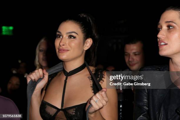 Television personality Ashley Iaconetti watches Jared Haibon's performance after catching his tie as Jade Roper looks on at Chippendales at the Rio...