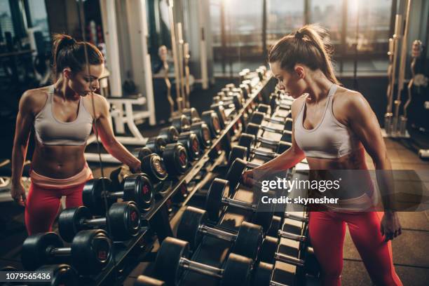 Female Racking Weights 1,007 Gym Weight Rack Stock Photos, High-Res Pictures, and Images ...