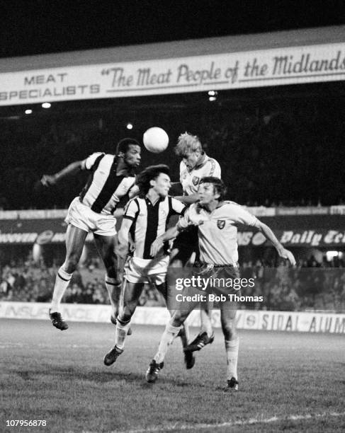 Cyrille Regis and Bryan Robson of West Bromwich Albion clash with Roger Brown and Martin Peters of Norwich City during their Division One match held...