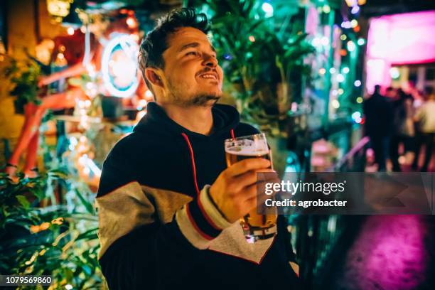 happy man enjoying in beer in pub - budapest nightlife stock pictures, royalty-free photos & images