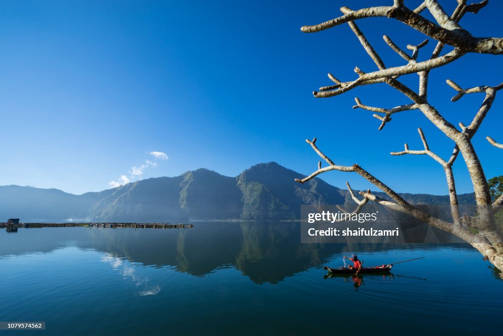 Morning scene of Lake Batur with fisherman daily activity.