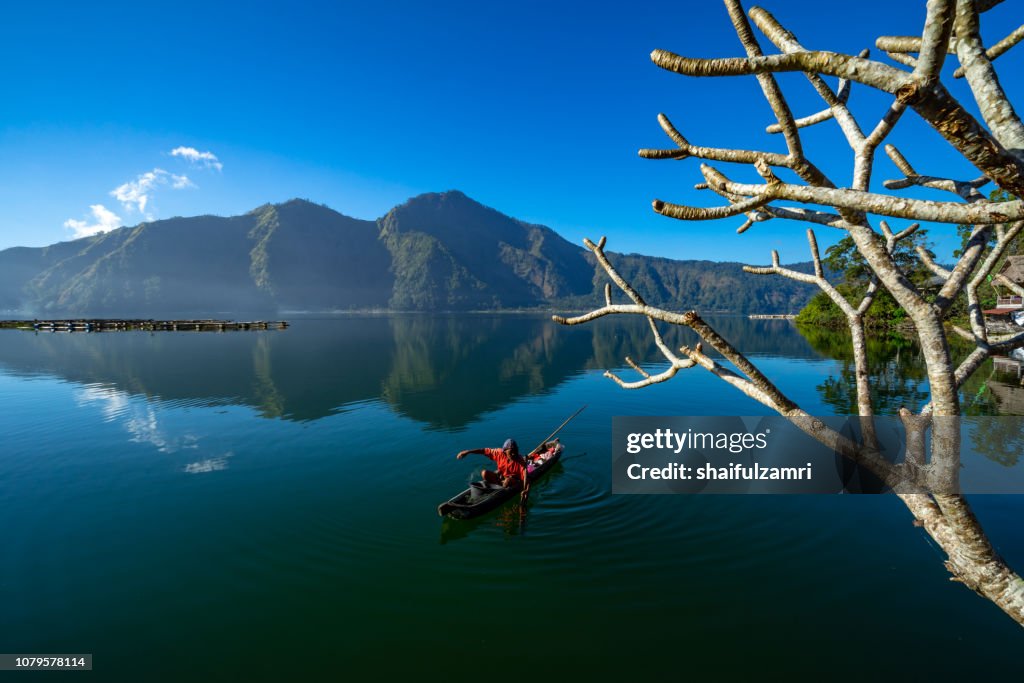 Morning scene of Lake Batur with fisherman daily activity.