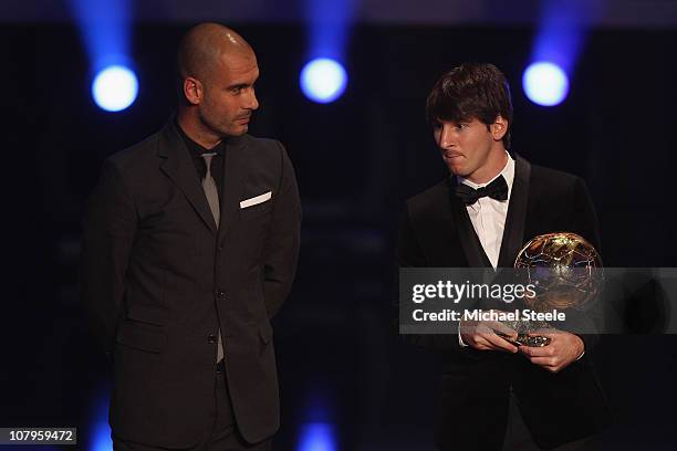 Lionel Messi of Argentina and Barcelona FC receives the men's player of the year award from his club coach Pep Guardiola during the FIFA Ballon d'or...