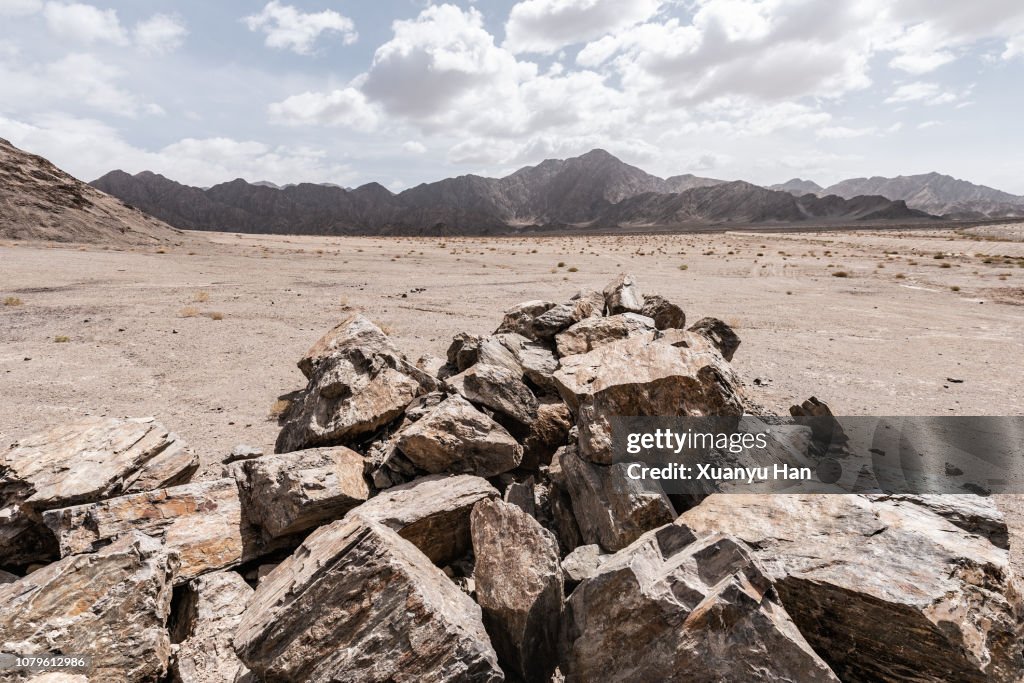 Huge heap with boulders in front of the mountain