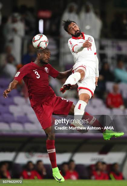 Abdelkarim Hassan of Qatar competes with Abdullah Otayf of Lebanon during the AFC Asian Cup Group E match between Qatar and Lebanon at Hazza Bin...