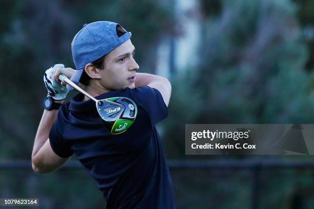 Actor Tom Holland plays a shot during a practice round ahead of the Sony Open In Hawaii at Waialae Country Club on January 9, 2019 in Honolulu,...