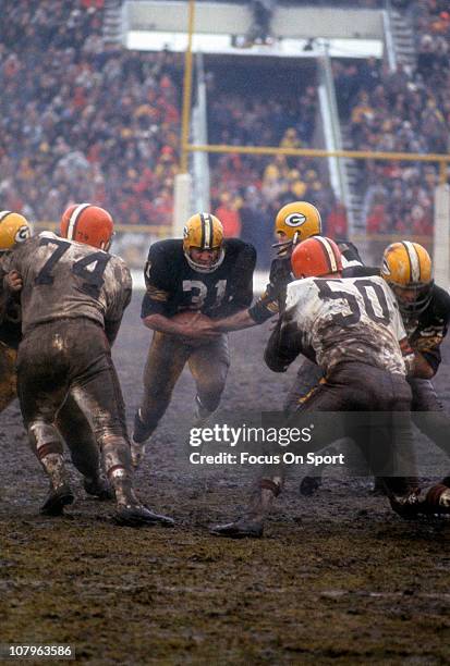 Running back Jim Taylor of the Green Bay Packers carries the ball against the Cleveland Browns during an NFL football game at Lambeau Field circa...