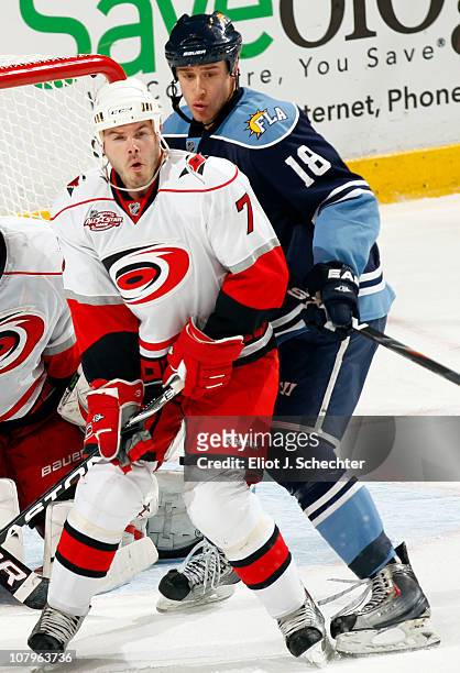Ian White of the Carolina Hurricanes tangles with Shawn Matthias of the Florida Panthers at the BankAtlantic Center on January 7, 2011 in Sunrise,...