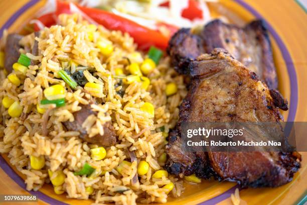 cuban cuisine: deep pork fried and yellow rice - cuban culture stock pictures, royalty-free photos & images