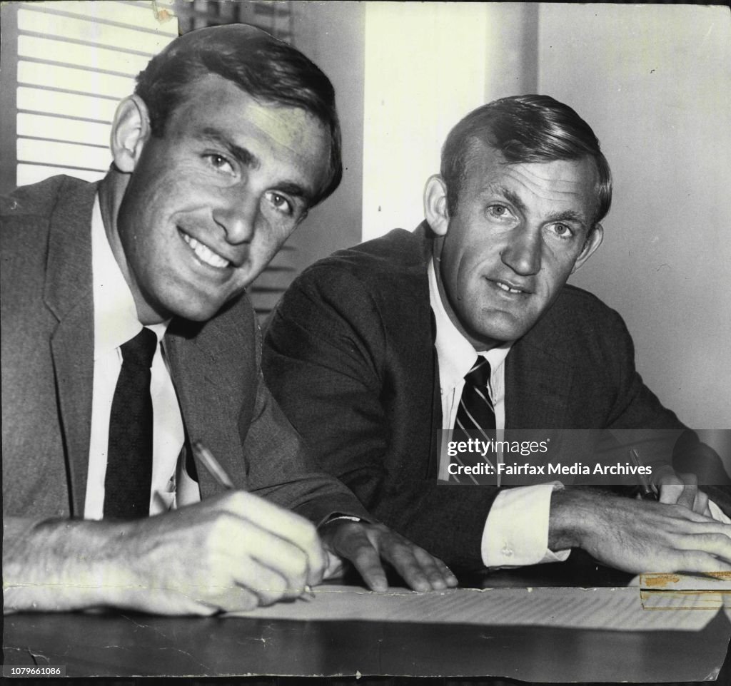 Tony Roche & John Newcombe Australian tennis stars today signed their contracts to turn professional.Dave Dixon's tennis circus is headed by the two Australian stars Tony Roche and John Newcombe. Here the two of them are shown signing on the dotted line.
