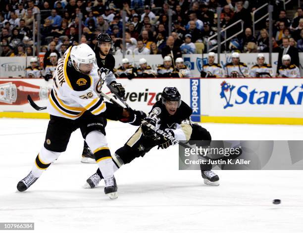 Johnny Boychuk of the Boston Bruins takes a shot against Tyler Kennedy of the Pittsburgh Penguins on January 10, 2011 at Consol Energy Center in...