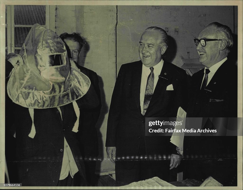 Mr. A.R. Sloss M.L.A. (left) tries on an asbestos mask made at the plant, much to the amusement of Premier Mr. Askin (centre) and the Chairman and Managing Director Mr.C.S.Nicholson.The Premier Mr. R.N. Askin today officially opened the new plant of Nicho