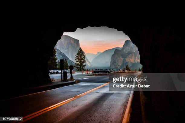 the yosemite tunnel view from inside tunnel road during sunset. - yosemite stock-fotos und bilder