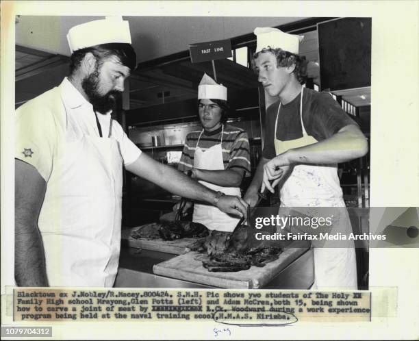 Two students of the Holy Family High school Marayong, Glen Potts and Adam McCrea, both 15, being shown how to carve a joint of meat by L.Ck. Woodward...