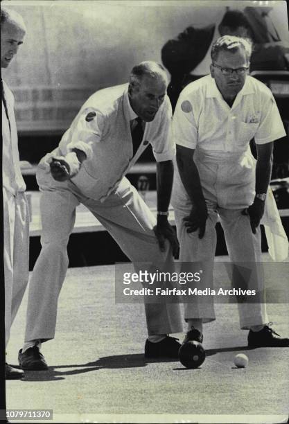 Scotland's Harry Reston "talks in" a bowl as a worried opponent looks on. October 12, 1966. .