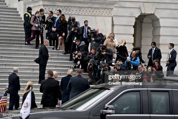 President Donald Trump, center left, speaks to members of the media while arriving to the U.S. Capitol for a meeting with Senate Republicans with...