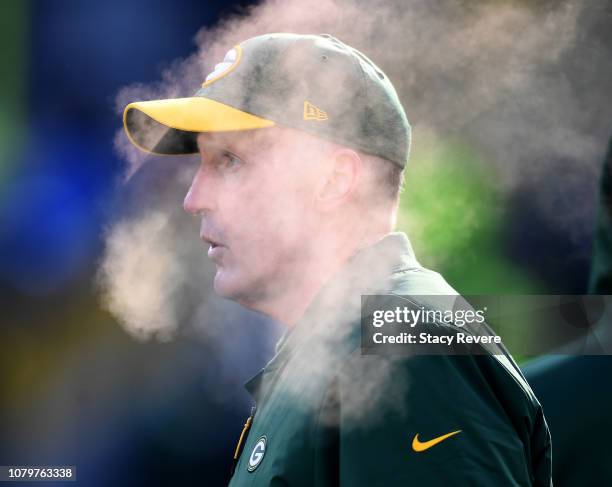 Head coach Joe Philbin of the Green Bay Packers watches his team during warmups before a game against the Atlanta Falcons at Lambeau Field on...