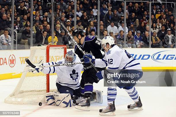 Jarret Stoll of the Los Angeles Kings battles for the puck against James Reimer and Tyler Bozak of the Toronto Maple Leafs at Staples Center on...