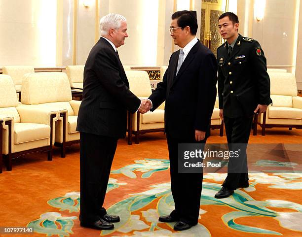 Secretary of Defense Robert Gates and China's President Hu Jintao shake hands at the Great Hall of the People on January 11, 2011 in Beijing, China....