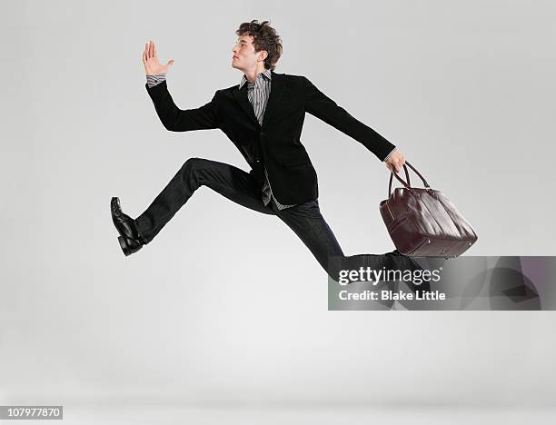 man jumping with bag - fast studio ストックフォトと画像