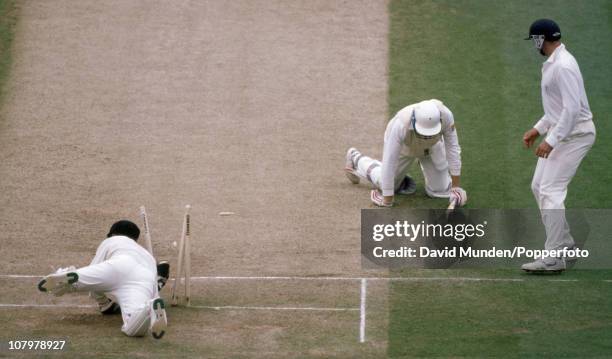 England batsman Michael Atherton is run out by Australian wicketkeeper Ian Healy for 99 runs in the second innings of the 2nd Test match between...
