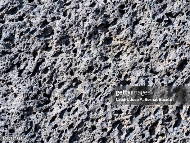 complete setting of the textures of the face of a volcanic rock with lava textures. - vulkanisch gesteente stockfoto's en -beelden