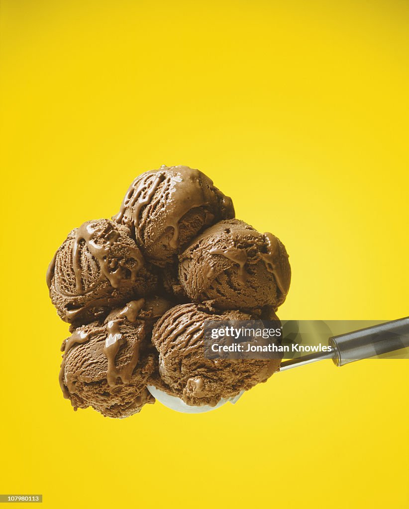 Chocolate ice cream against yellow background