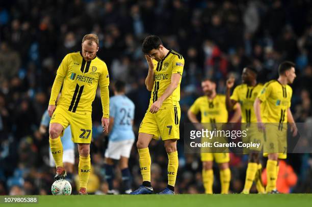 Liam Boyce and Scott Fraser of Burton Albion look dejected as Manchester City score their seventh goal during the Carabao Cup Semi Final First Leg...