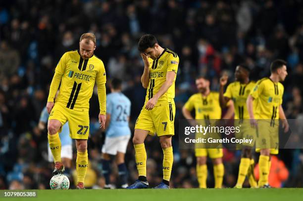 Liam Boyce and Scott Fraser of Burton Albion look dejected as Manchester City score their seventh goal during the Carabao Cup Semi Final First Leg...
