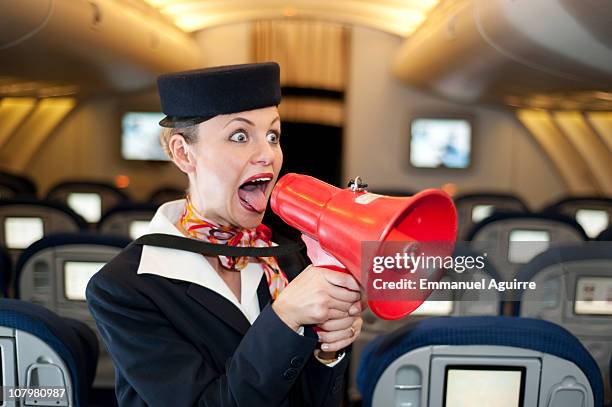 stewardess with megaphone - stewardess stock-fotos und bilder