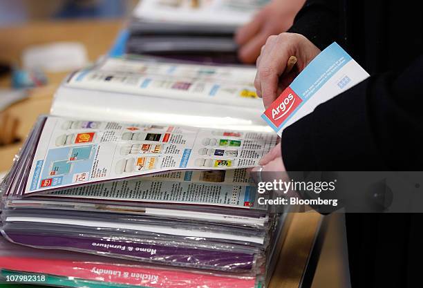 Customers browse catalogues at an Argos store, operated by Home Retail Group Plc, in London U.K., on Tuesday, Jan. 11, 2011. U.K. Retail sales fell...