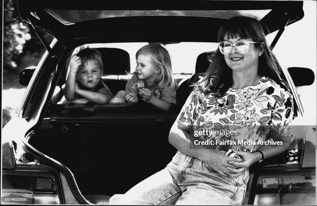 Anne Parsons with children Iain, 4, Sophie, 2...Anne and children with the small family car.