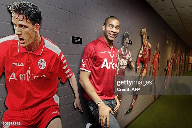 Oguchi Onyewu stands among cut-outs of other FC Twente players as he presents himself at Dutch football club FC Twente to sign a contract with them,...