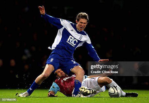 Alexander Hleb of Birmingham is tackled by Matthew Upson of West Ham during the Carling Cup Semi Final first leg match between West Ham United and...